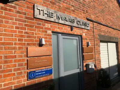 The Maas Clinic exterior signage: metal fascia lettering and copper acrylic name plaques on red brickwork