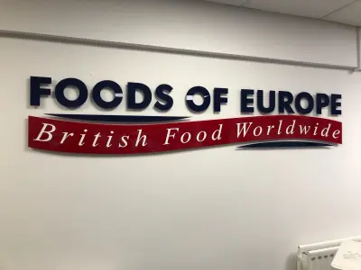 Foods of Europe British Food Worldwide built-up wall sign in navy and red on a white wall