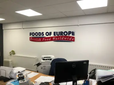 Foods of Europe British Food Worldwide wall sign above an office desk with a Dell monitor