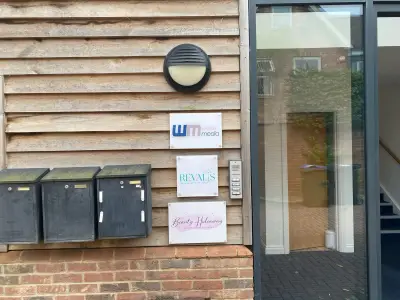 Exterior acrylic signs for wake media, Revalis and Beauty Hideaway on timber cladding by an entrance