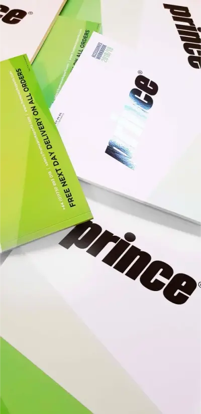 Printed Prince brand brochures with green and white covers and foil logos