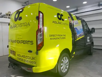 Adlar Castra lime-green Ford Transit Custom van, full wrap, rear view showing website and phone