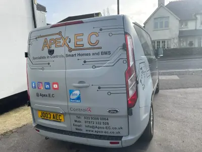 Silver Ford Transit Custom van, Apex EC part wrap, rear with social media icons and contact details