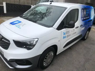 White Vauxhall Combo van, part wrap for DJK Electrical Contractors, front with blue graphics