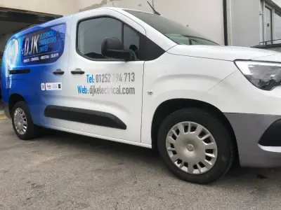 White Vauxhall Combo van, DJK Renewables full wrap, passenger-side front with solar-panel design