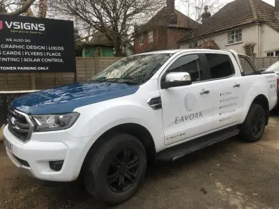White Ford Ranger pickup, part wrap for Eavoak garden buildings, driver side with blue bonnet