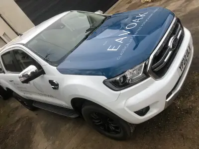 White Ford Ranger pickup, Eavoak part wrap with blue signwritten bonnet, front angle