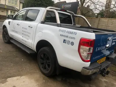 White Ford Ranger pickup, Eavoak part wrap, rear side with blue tailgate and services list