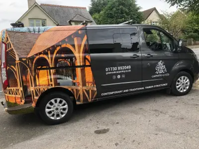 Nearside of grey Ford Transit Custom van with The Green Oak Carpentry timber-frame photo wrap