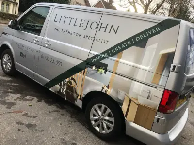 Front quarter of silver Littlejohn Bathroom Specialist VW Transporter with bathroom photo part wrap