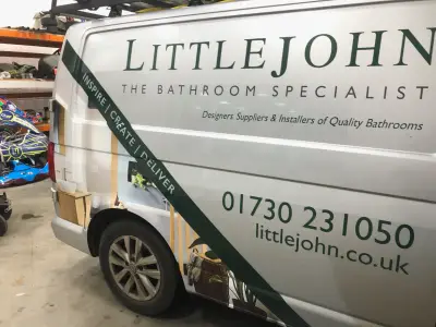 Close side view of silver Littlejohn Bathroom Specialist VW Transporter signwriting and part wrap