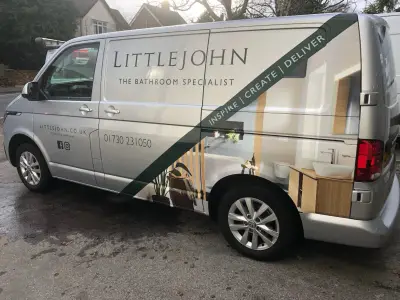 Nearside rear of silver Littlejohn Bathroom Specialist VW Transporter with bathroom photo part wrap