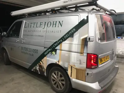 Offside rear of silver Littlejohn Bathroom Specialist VW Transporter with signwriting and part wrap