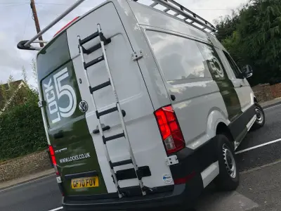 Rear of white VW Crafter van with green Lock5 part wrap, logo and web address