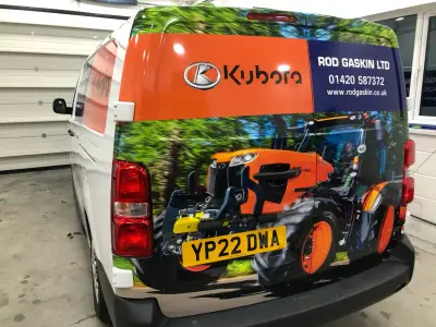 Rear of white van with Kubota tractor photo wrap and Rod Gaskin Ltd contact details