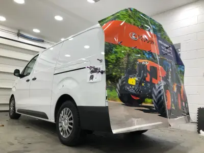 Rear vinyl wrap being applied to a white van with Rod Gaskin Kubota tractor graphics