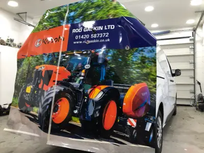 Rod Gaskin Kubota tractor rear wrap being installed on a white van, panel nearly complete