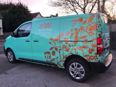 Turquoise van fully wrapped with Silent Pool Gin copper floral graphics, side view