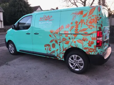 Silent Pool Gin turquoise van wrap with copper botanical detail, driver-side view
