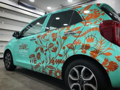 Silent Pool Gin turquoise car wrap detail with copper flowers and crown motif