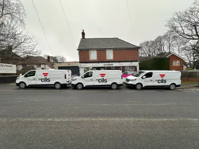 Row of three white cils Renault Trafic vans with fleet vehicle graphics outside the V Signs premises