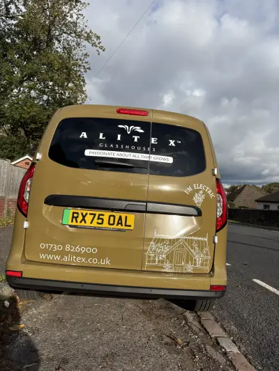 Rear of an Alitex Glasshouses Ford Transit Connect in printed olive with greenhouse line art and window graphics