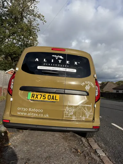 Rear of an Alitex Glasshouses Ford Transit Connect in printed olive with signwritten window graphics and greenhouse art