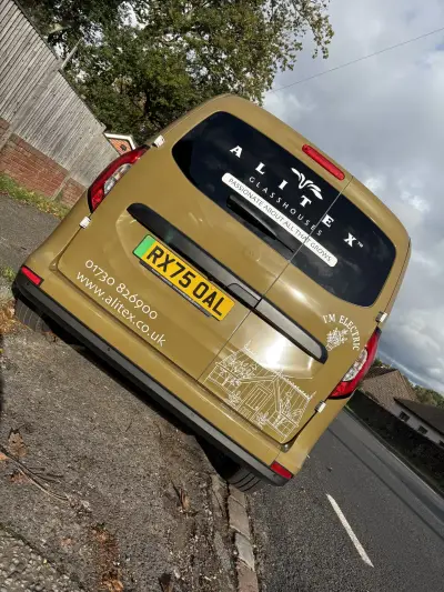 Rear of olive-gold Alitex Glasshouses van with window graphics and greenhouse illustration