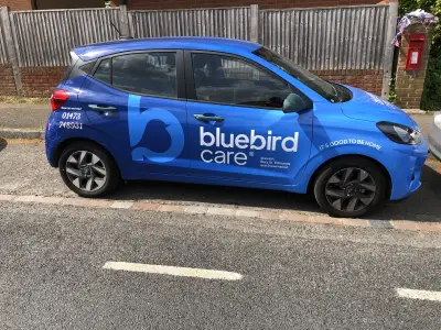 Blue Hyundai i10 side with Bluebird Care Ipswich full wrap, 'It's good to be home'