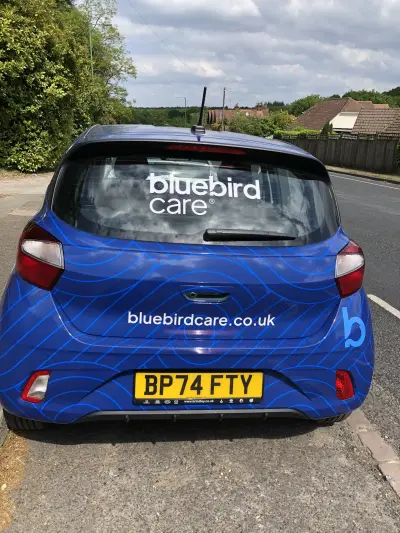 Rear of blue Hyundai i10 with Bluebird Care full wrap and bluebirdcare.co.uk lettering
