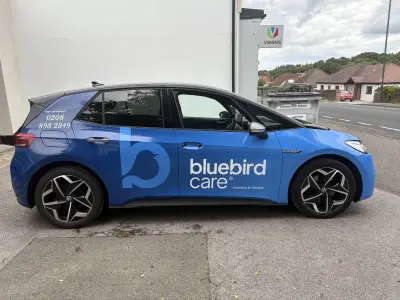Blue VW ID.3 side with Bluebird Care Hounslow & Chiswick full wrap and bird logo