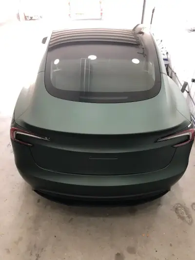 Rear of a Tesla Model S finished in a matt metallic pine green colour-change wrap
