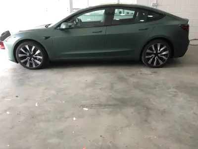 Tesla Model S in a matt metallic pine green colour-change wrap, full driver-side profile