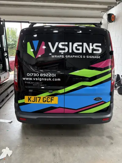 Rear of black Ford Transit Connect wrapped with colourful VSIGNS branding and graphics