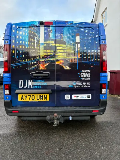 Rear view of DJK Electrical Contractors Limited blue van with cityscape full wrap