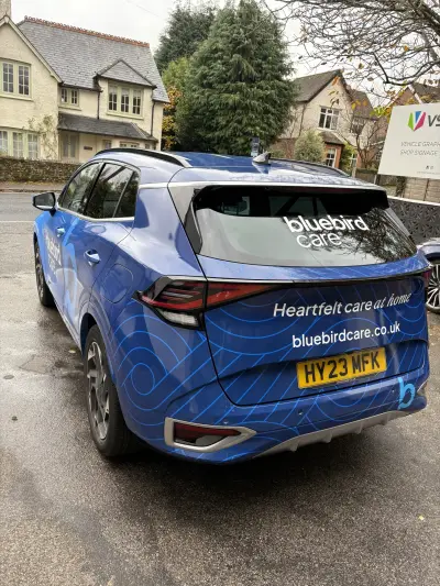 Rear of blue Kia Sportage SUV, Bluebird Care 'Heartfelt care at home' full wrap