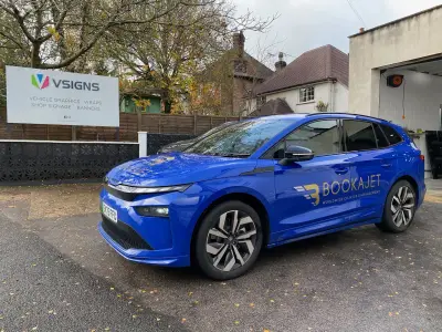 Blue estate car with gold BOOKAJET Worldwide Charter & Management wrap by V Signs board