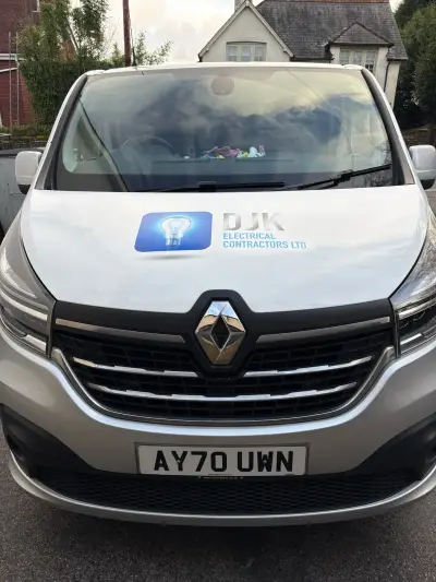 Front of silver Renault Trafic van with DJK Electrical Contractors bonnet graphic
