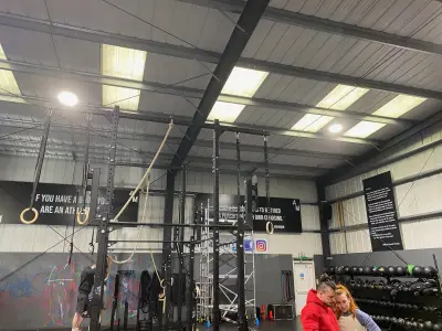 Gym interior with printed motivational wall panels including Invictus poem and quote boards