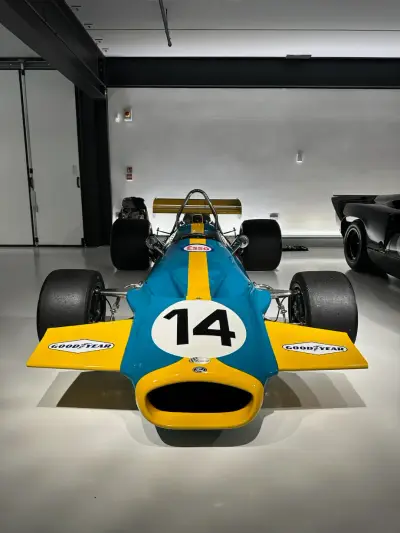 Head-on front view of teal and yellow F1 single-seater number 14 with Esso and Goodyear decals