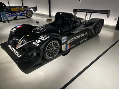 Black Motorola Lola LMP prototype number 25 with elf and Pirelli decals, front three-quarter view
