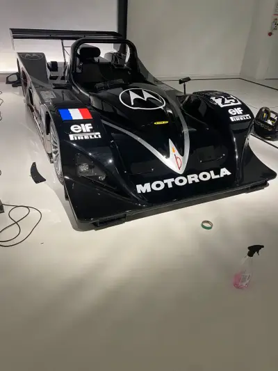 Elevated front view of black Motorola-liveried Lola LMP prototype number 25 with elf and Pirelli decals