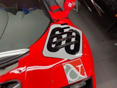 Red McLaren F1 GTR bonnet with black number 60 roundel and Lark logo, race livery