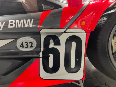 Black number 60 door panel on red and grey BMW-liveried McLaren F1 GTR