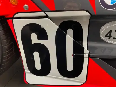 Close-up of black number 60 door panel on red and grey McLaren F1 GTR livery