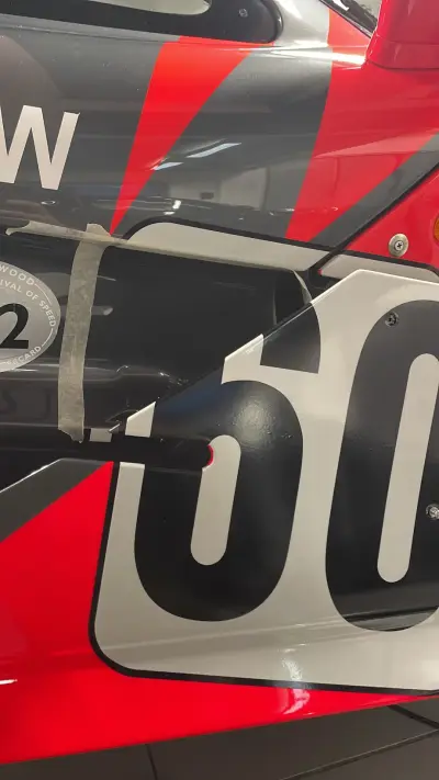 Number 60 door panel alignment detail on red and grey McLaren race livery