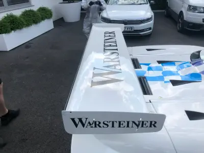 Warsteiner rear wing and blue checkered engine cover detail on white McLaren race car