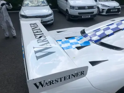 Warsteiner rear wing and blue checkered engine cover graphics on white McLaren race car
