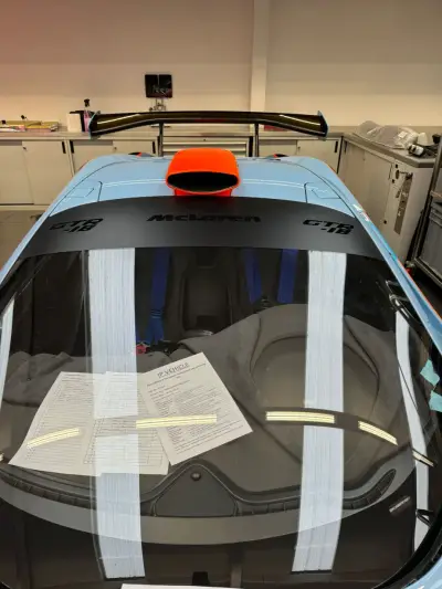 Gulf blue McLaren GTR-18 roof and orange air scoop viewed from front in workshop