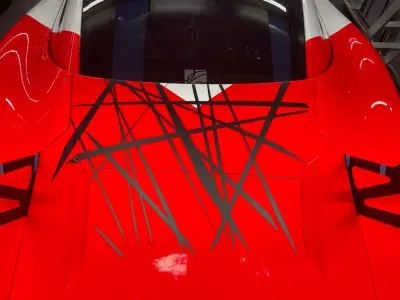 Red Porsche 935 bonnet with black abstract scratch-line motorsport livery graphics